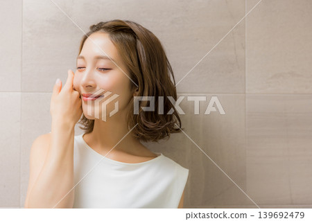 Young woman looking at a mirror Young woman looking at a mirror 139692479