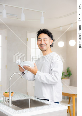 A man standing in the kitchen 139692569
