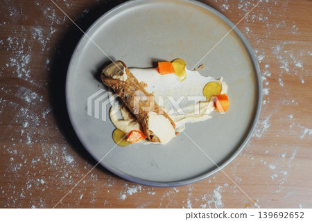 Top-down view of gourmet dessert on gray plate Top-down view of gourmet dessert on gray plate 139692652