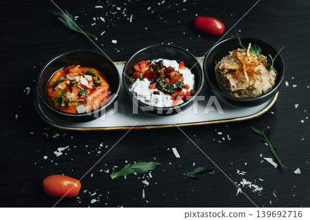 Delicious, colorful starters arranged artistically on a sleek tray Delicious, colorful starters arranged artistically on a sleek tray 139692716