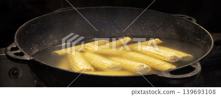 Yellow corn is cooked in a large cauldron Yellow corn is cooked in a large cauldron 139693108