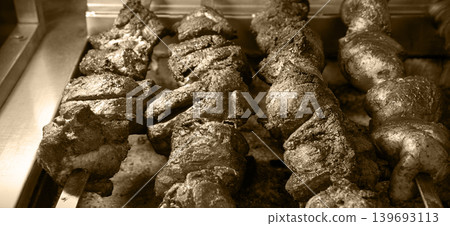A ruddy kebab is being grilled on a barbecue A ruddy kebab is being grilled on a barbecue 139693113