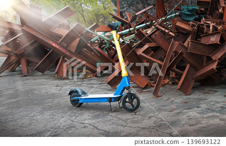 A scooter against the backdrop of iron anti-tank hedgehogs A scooter against the backdrop of iron anti-tank hedgehogs 139693122