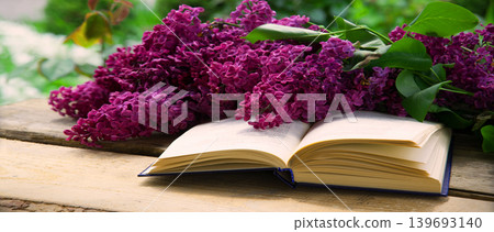 Lilac and book on the table Lilac and book on the table 139693140