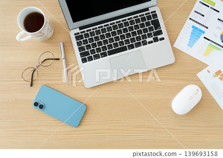 A laptop and stationery placed on the desk A laptop and stationery placed on the desk 139693158
