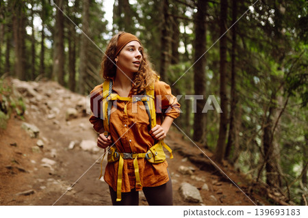 Young woman with backpack traveling outdoors. Hiking, active lifestyle. 139693183