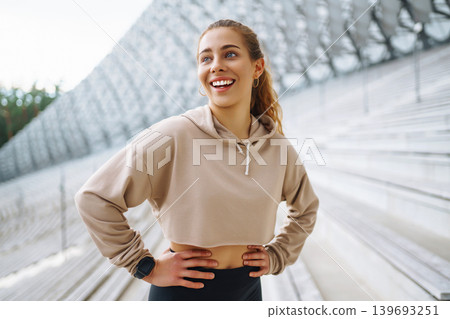 A young female athlete in special clothing is training on the court. Concept of sport, health. A young female athlete in special clothing is training on the court. Concept of sport, health. 139693251
