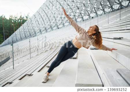 A young female athlete in special clothing is training on the court. Concept of sport, health. A young female athlete in special clothing is training on the court. Concept of sport, health. 139693252