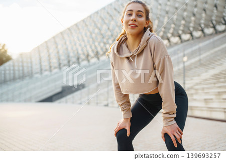 A young female athlete in special clothing is training on the court. Concept of sport, health. A young female athlete in special clothing is training on the court. Concept of sport, health. 139693257
