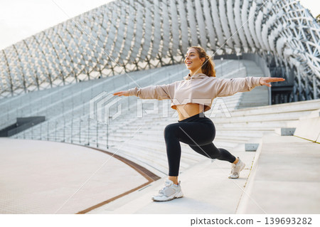 A young female athlete in special clothing is training on the court. Concept of sport, health. A young female athlete in special clothing is training on the court. Concept of sport, health. 139693282