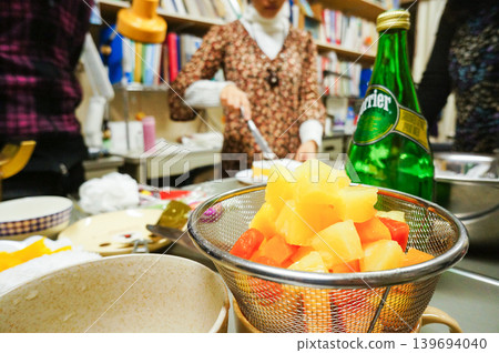 A scene from a home kitchen where fruit is being prepared. A scene from a home kitchen where fruit is being prepared. 139694040