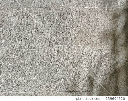Textured gray concrete wall with soft diagonal shadow, minimalist urban background with rough surface, neutral tones and copy space Textured gray concrete wall with soft diagonal shadow, minimalist urban background with rough surface, neutral tones and copy space 139694620