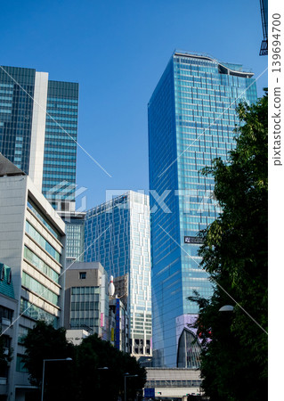 Shibuya's modern skyscrapers and cityscape stand out against the blue sky. Shibuya's modern skyscrapers and cityscape stand out against the blue sky. 139694700
