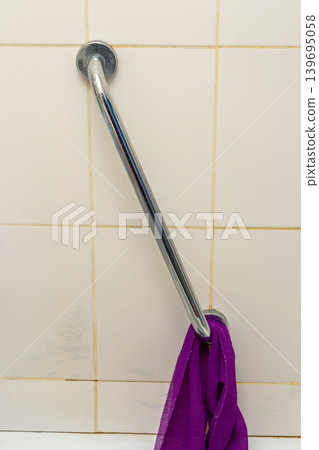 Bathroom Grab Bar With Purple Towel Hanging on Tiled Shower Wall for Safety and Accessibility Bathroom Grab Bar With Purple Towel Hanging on Tiled Shower Wall for Safety and Accessibility 139695058