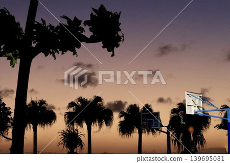 Magic hour and a child playing basketball Magic hour and a child playing basketball 139695081