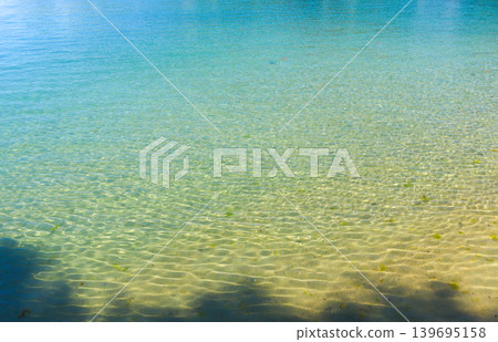 The clear blue waters of the island's sea The clear blue waters of the island's sea 139695158