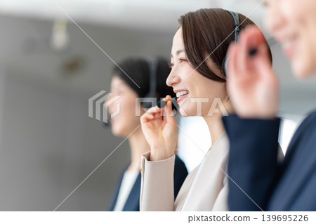 Female operator working in a call center Female operator working in a call center 139695226