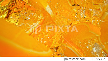 Fresh orange slices falling into sparkling water with bubbles and splashes. Vibrant citrus macro photo, perfect for beverage, freshness, summer, cocktail and healthy lifestyle visuals. Fresh orange slices falling into sparkling water with bubbles and splashes. Vibrant citrus macro photo, perfect for beverage, freshness, summer, cocktail and healthy lifestyle visuals. 139695334