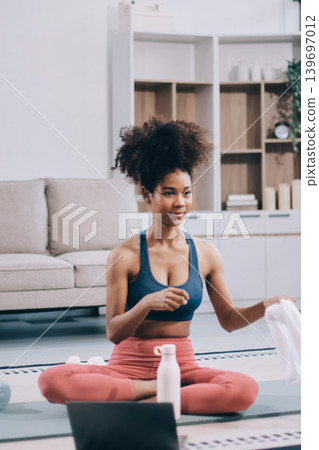 Women exercising in fitness studio yoga classes Women exercising in fitness studio yoga classes 139697012
