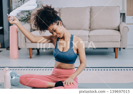 Women exercising in fitness studio yoga classes Women exercising in fitness studio yoga classes 139697015