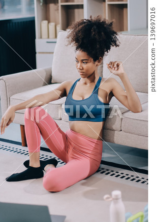Women exercising in fitness studio yoga classes Women exercising in fitness studio yoga classes 139697016