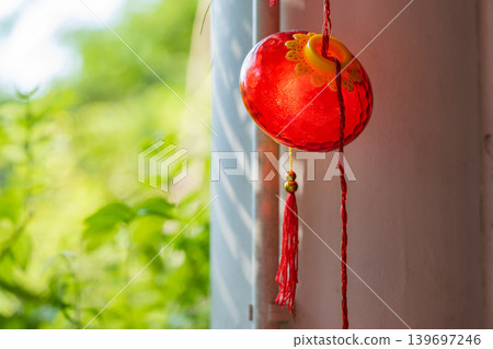 Red traditional Chinese lantern decorated at the wooden arch of the entrance to Lunar New Year festival. Red traditional Chinese lantern decorated at the wooden arch of the entrance to Lunar New Year festival. 139697246
