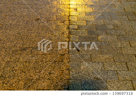 Wet Brick Pavement at Night With Reflective Street Lighting and Urban Texture Wet Brick Pavement at Night With Reflective Street Lighting and Urban Texture 139697318