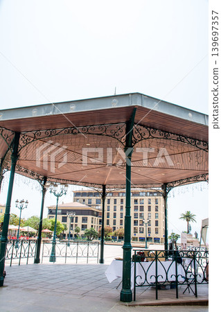 A gazebo built in the middle of the square; the cityscape of Ajaccio, on the French island of Corsica in the Mediterranean Sea. A gazebo built in the middle of the square; the cityscape of Ajaccio, on the French island of Corsica in the Mediterranean Sea. 139697357