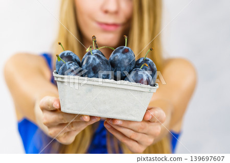 Girl holds plum fruits 139697607