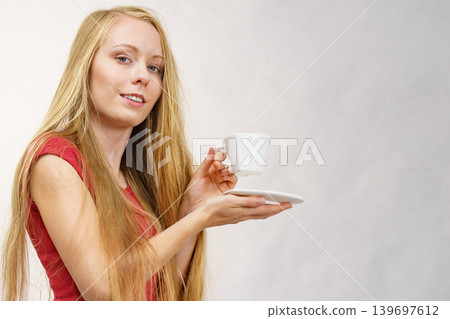 Blonde girl with coffee cup Blonde girl with coffee cup 139697612