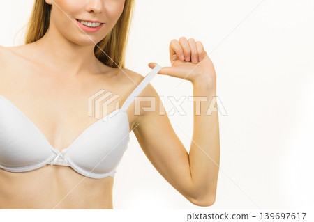 Young woman holding bra strap 139697617