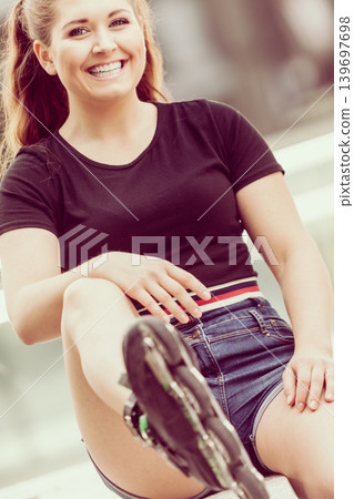 Young woman riding roller skates 139697698