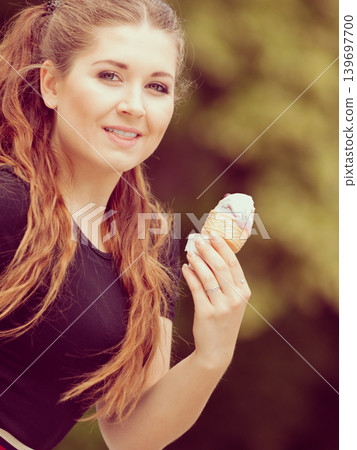 Young woman eating ice cream 139697700