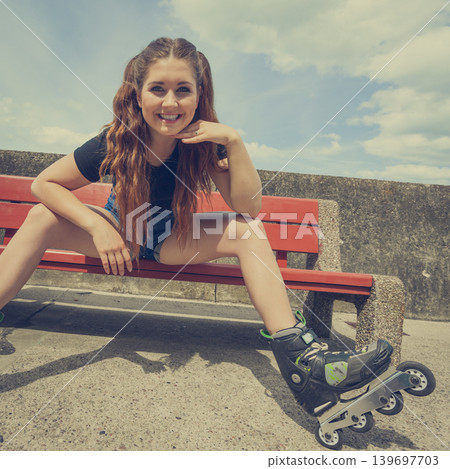Smiling girl with roller skates outdoor Smiling girl with roller skates outdoor 139697703
