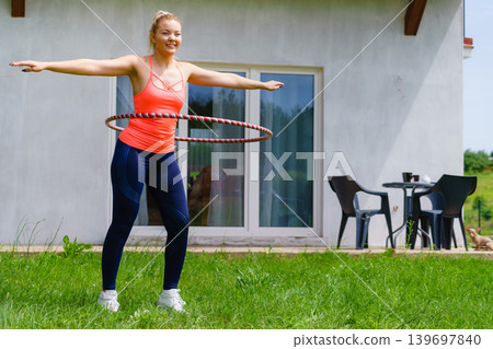 Young woman with hoola hoop outdoors 139697840