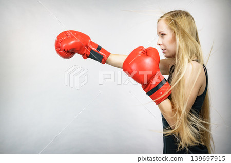 Girl in red gloves playing sports boxing Girl in red gloves playing sports boxing 139697915