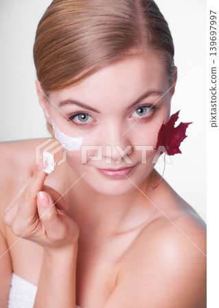 Skin care. Face of young woman girl with red maple leaf. 139697997
