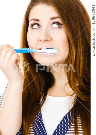 Woman brushing cleaning teeth. Woman brushing cleaning teeth. 139698041