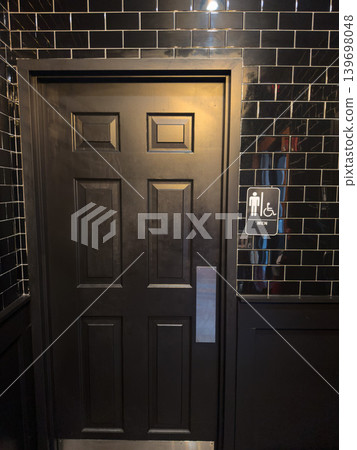 Black tiled wall and men's bathroom entrance sign. Modern toilet door. Black tiled wall and men's bathroom entrance sign. Modern toilet door. 139698048