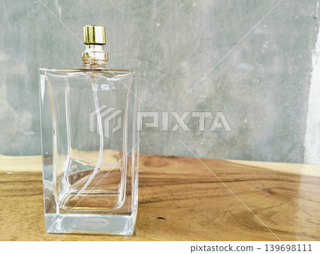Empty Perfume Bottle on Wooden Texture Background Empty Perfume Bottle on Wooden Texture Background 139698111