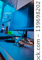 Aesthetic Blue Workspace Setup Featuring Cute Dinosaur Figure And Neon Computer Lighting 139698202