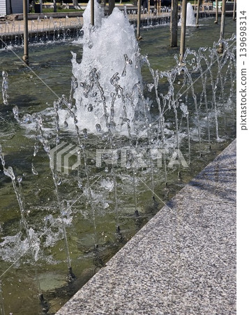 Close up of crystal clear fountain splashes. Close up of crystal clear fountain splashes. 139698314