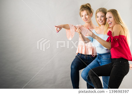 Three fashionable females pointing Three fashionable females pointing 139698397
