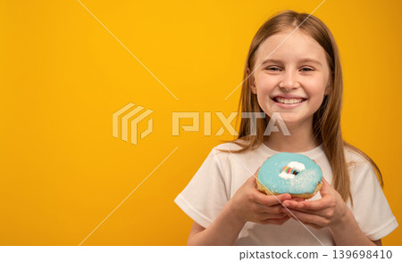 Cute Smiling Little Girl With A Sweet Donut On An Orange Background Cute Smiling Little Girl With A Sweet Donut On An Orange Background 139698410