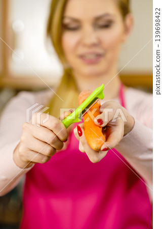 Woman peeling carrot vegetable Woman peeling carrot vegetable 139698422