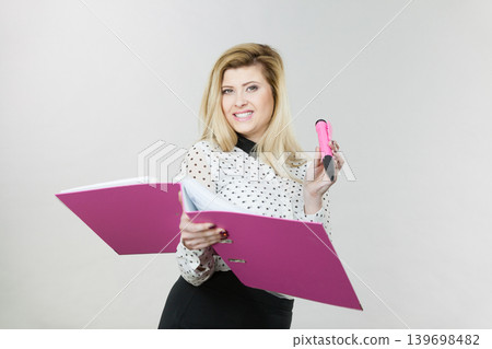 Happy positive business woman holding binder Happy positive business woman holding binder 139698482
