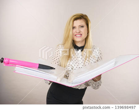 Happy positive business woman holding binder with documents Happy positive business woman holding binder with documents 139698497