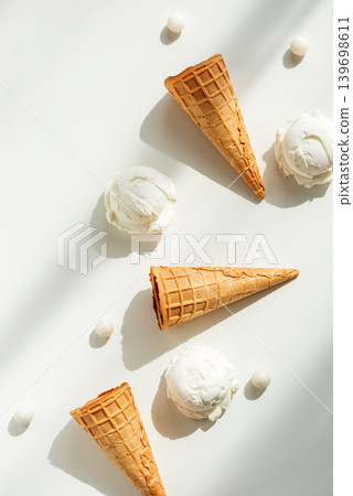 Vanilla Ice Cream Cones with Scoops on White Table Vanilla Ice Cream Cones with Scoops on White Table 139698611