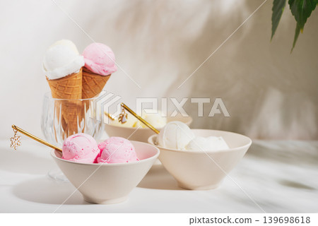 Ice Cream Cones and Bowls with Strawberries and Mint on White Background Ice Cream Cones and Bowls with Strawberries and Mint on White Background 139698618