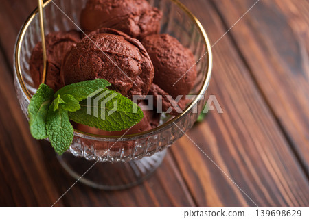 Chocolate Ice Cream with Mint Leaves on Dark Wooden Background 139698629